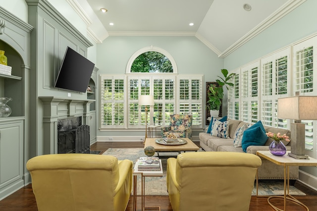 living area with vaulted ceiling, ornamental molding, dark wood-type flooring, and a fireplace
