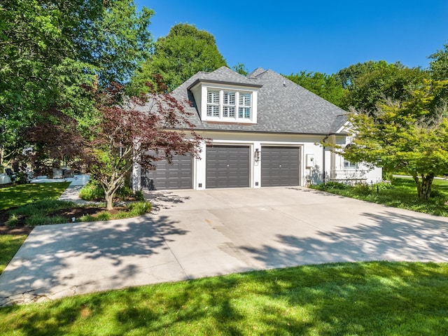 view of side of home featuring driveway, a shingled roof, and a garage