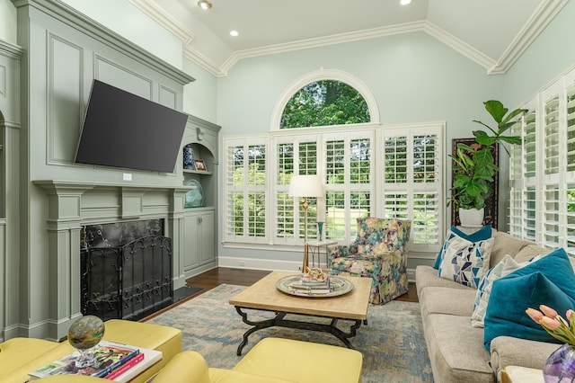living room featuring crown molding, dark wood finished floors, a wealth of natural light, and a fireplace