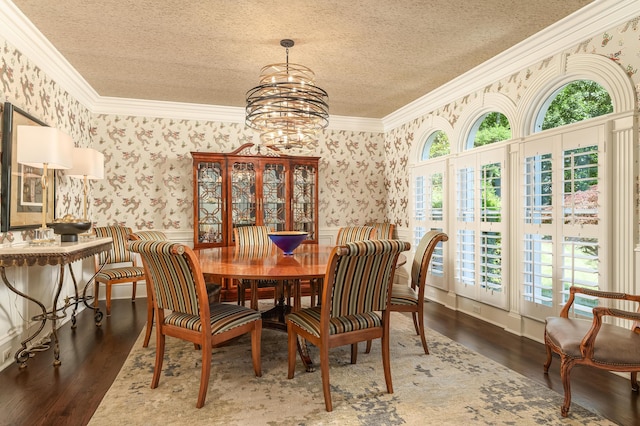 dining area with crown molding, a textured ceiling, and wallpapered walls