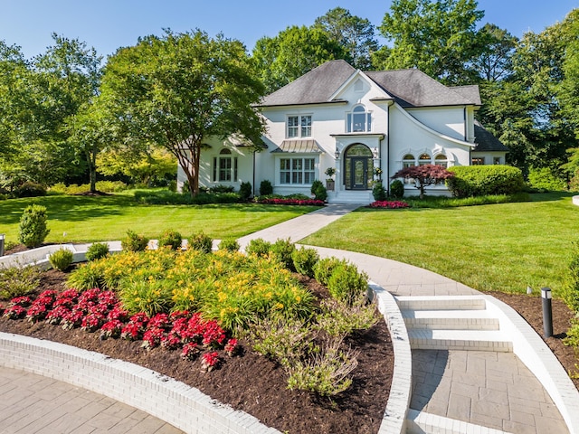 view of front of house with a front lawn and stucco siding