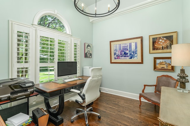 office space featuring crown molding, baseboards, wood finished floors, and a chandelier