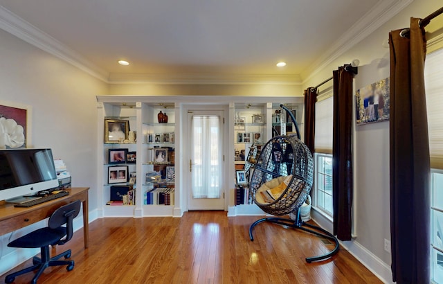 home office with ornamental molding, light wood-type flooring, and baseboards