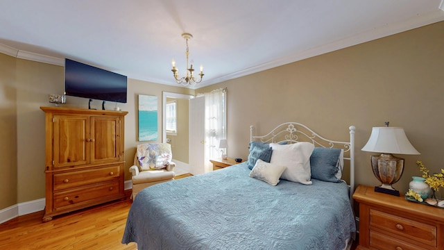 bedroom with a chandelier, light wood finished floors, baseboards, and crown molding