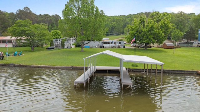 view of dock featuring a lawn and a water view