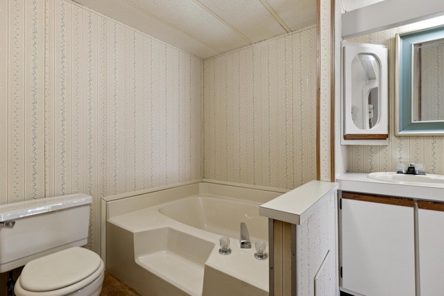 full bathroom with a garden tub, vanity, toilet, and wallpapered walls