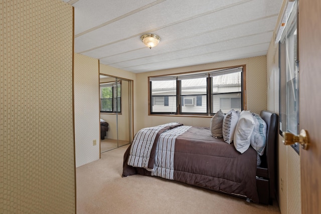 bedroom featuring a closet, carpet, and multiple windows