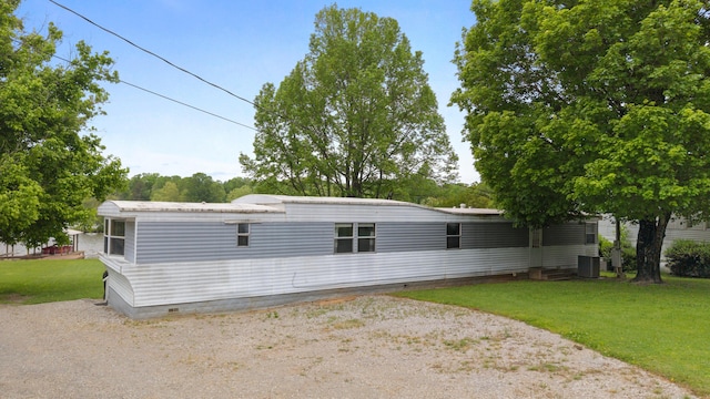 back of property featuring a yard, crawl space, and central AC unit