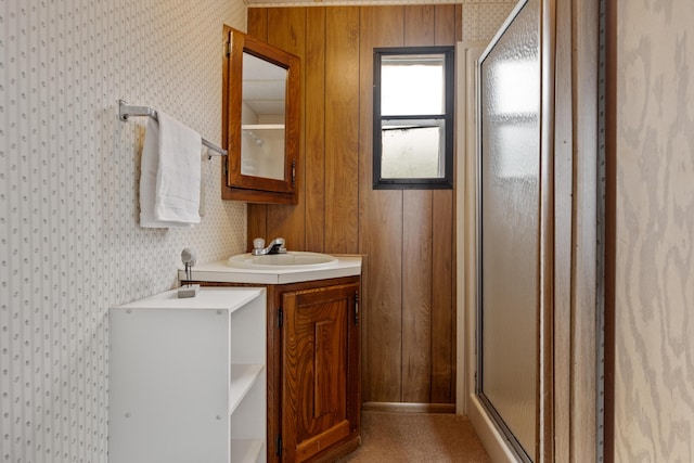 full bath with vanity, a stall shower, and wallpapered walls