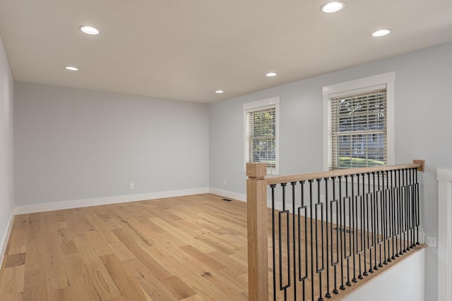 unfurnished room with hardwood / wood-style floors