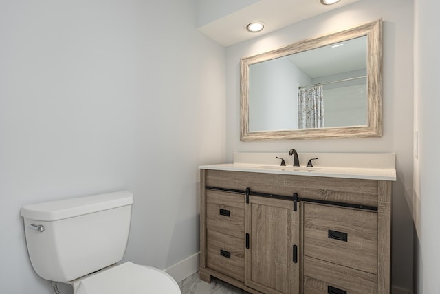 bathroom featuring vanity and toilet