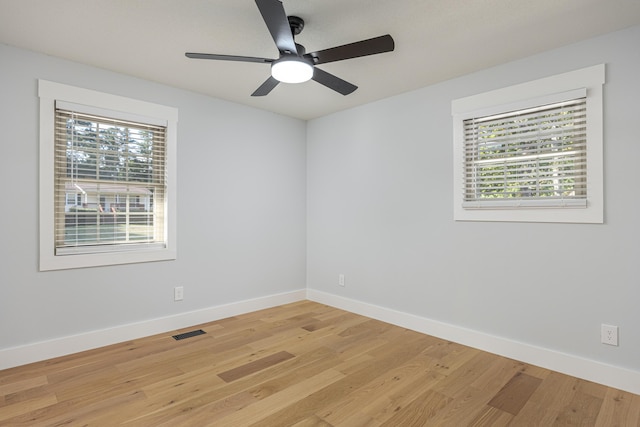 spare room with ceiling fan and light wood-type flooring