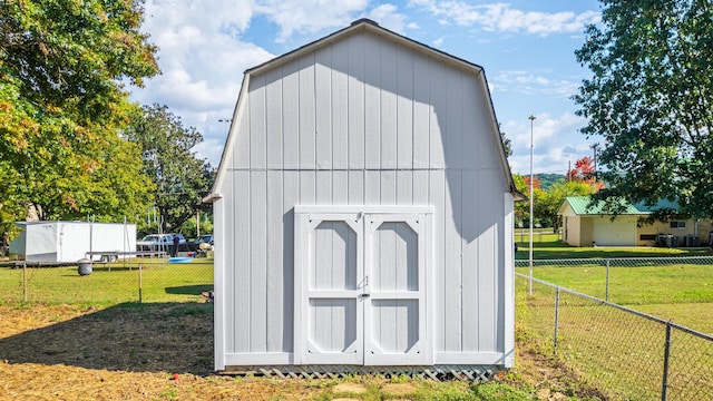 view of outdoor structure featuring a lawn