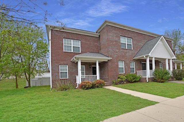 view of front of property featuring covered porch and a front yard