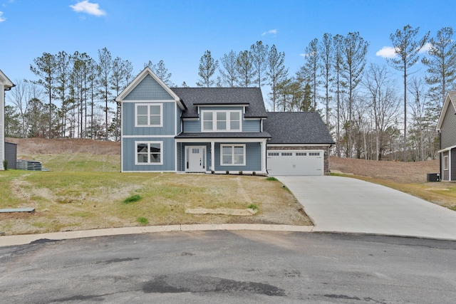 view of front of house featuring a front lawn and a garage