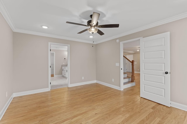 empty room with ceiling fan, crown molding, and light wood-type flooring