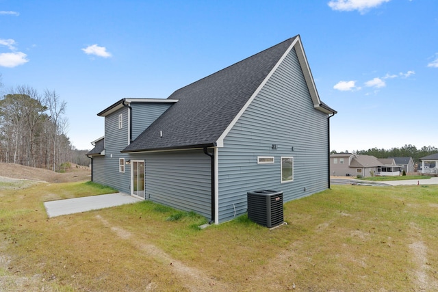 back of property with a yard, a patio area, and central air condition unit