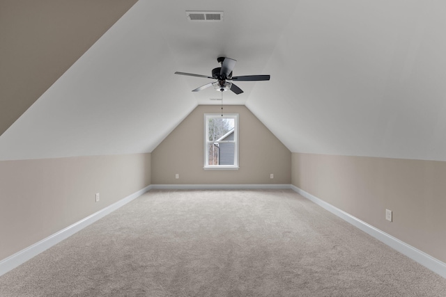 bonus room with ceiling fan, light carpet, and vaulted ceiling