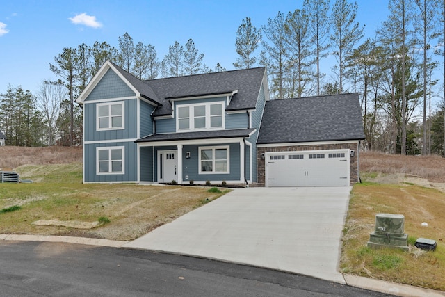 view of front of property with a garage and a front lawn