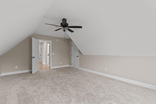 bonus room with ceiling fan, light colored carpet, and vaulted ceiling