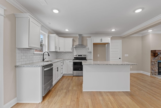 kitchen with white cabinetry, wall chimney exhaust hood, stainless steel appliances, tasteful backsplash, and light stone counters