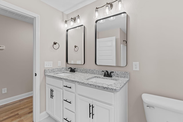 bathroom featuring vanity and toilet