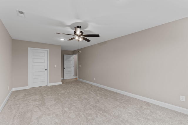 unfurnished bedroom featuring ceiling fan, light colored carpet, and a closet