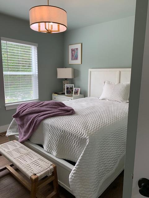 bedroom with dark hardwood / wood-style floors