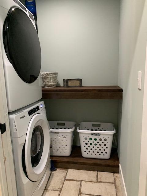 laundry room featuring stacked washer / drying machine