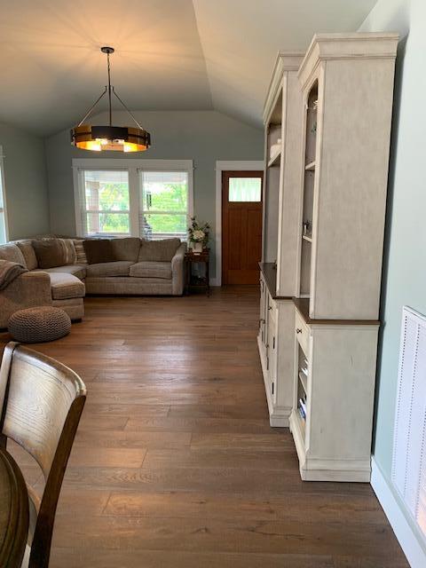 living room with lofted ceiling and dark hardwood / wood-style floors