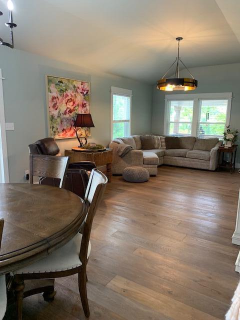 dining area with a wealth of natural light and hardwood / wood-style flooring