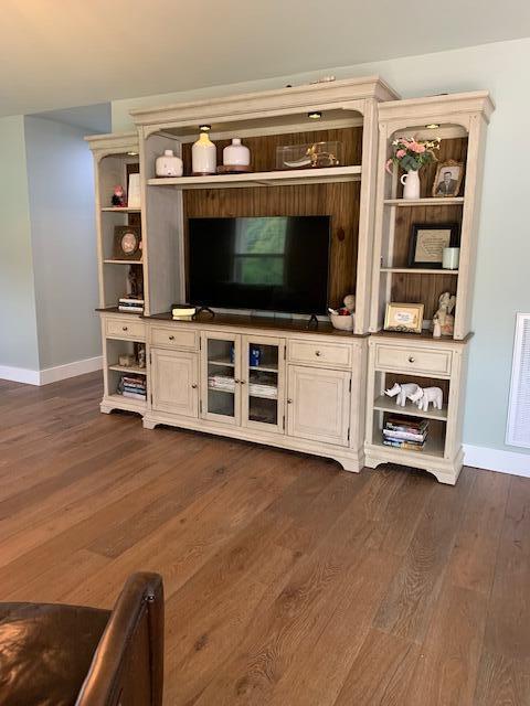 unfurnished living room with dark hardwood / wood-style floors