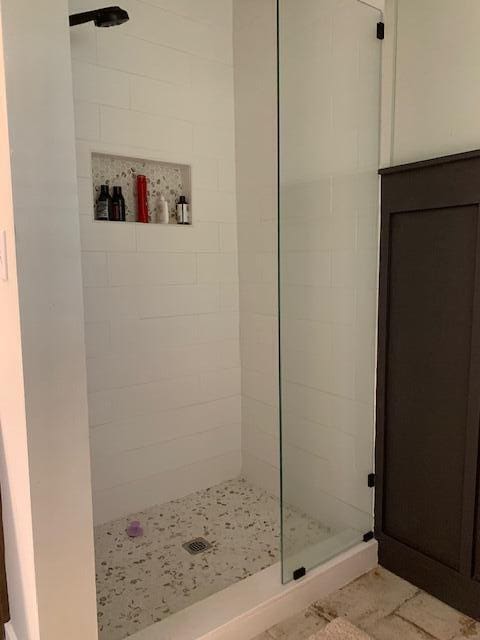 bathroom with a tile shower