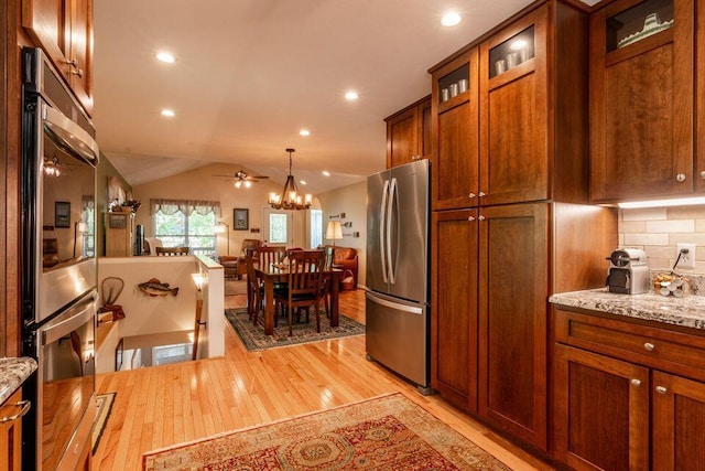 436 Oak Hills Drive Lots 4.5 & 6, Spring City, TN 37381 - kitchen featuring stainless steel appliances, light wood-style flooring, a chandelier, light stone counters, and vaulted ceiling