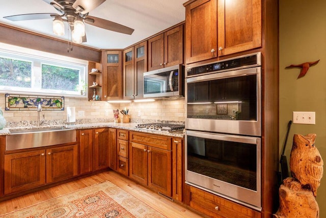 436 Oak Hills Drive Lots 4.5 & 6, Spring City, TN 37381 - kitchen featuring stainless steel appliances, a sink, light wood-style flooring, and backsplash