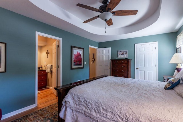 436 Oak Hills Drive Lots 4.5 & 6, Spring City, TN 37381 - bedroom featuring a raised ceiling, wood finished floors, baseboards, connected bathroom, and ceiling fan