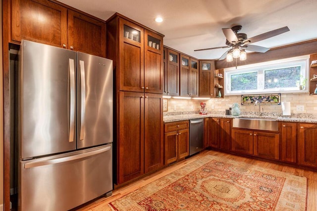 436 Oak Hills Drive Lots 4.5 & 6, Spring City, TN 37381 - kitchen with appliances with stainless steel finishes, a sink, open shelves, backsplash, and light wood-style flooring