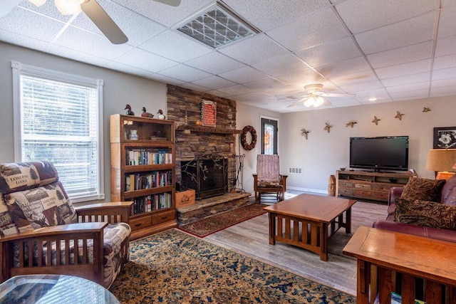 436 Oak Hills Drive Lots 4.5 & 6, Spring City, TN 37381 - living area featuring a ceiling fan, wood finished floors, a paneled ceiling, a fireplace, and baseboards
