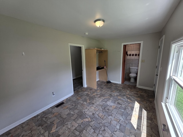 3817 Kirkland Ave, Chattanooga, TN 37410 - unfurnished bedroom with dark stone finish floors and ensuite bathroom