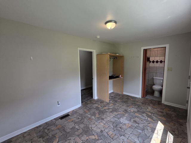 3817 Kirkland Ave, Chattanooga, TN 37410 - unfurnished bedroom with dark stone finish floors and connected bathroom