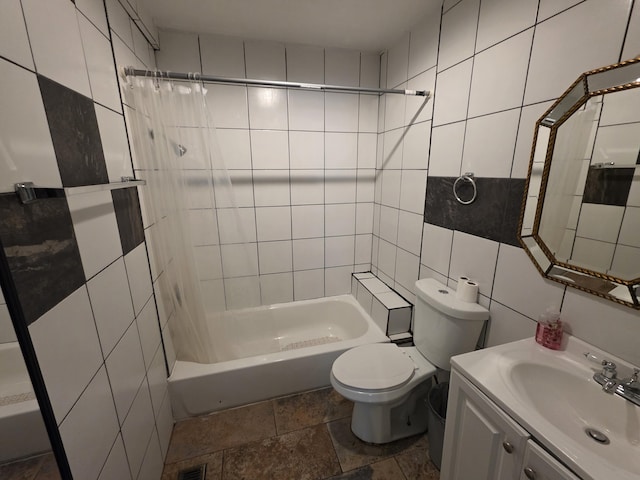 3817 Kirkland Ave, Chattanooga, TN 37410 - bathroom with tile walls, vanity, stone tile flooring, and  shower combination