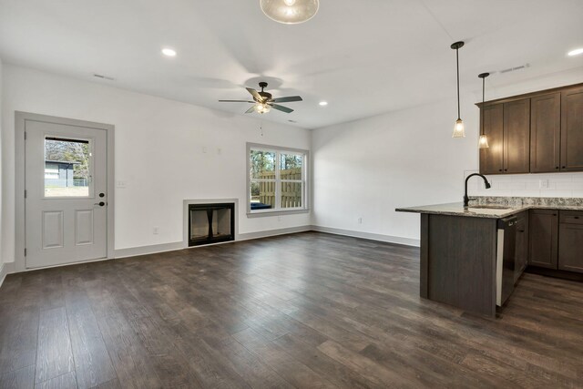 164 Mcnabb Dr, Cleveland, TN 37312 - kitchen featuring dark wood finished floors, dark brown cabinetry, light stone counters, dishwashing machine, and a sink