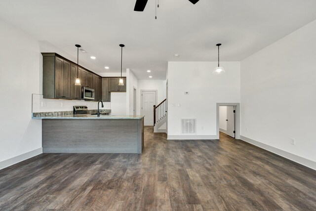 164 Mcnabb Dr, Cleveland, TN 37312 - kitchen with visible vents, a sink, stainless steel microwave, a peninsula, and dark brown cabinets