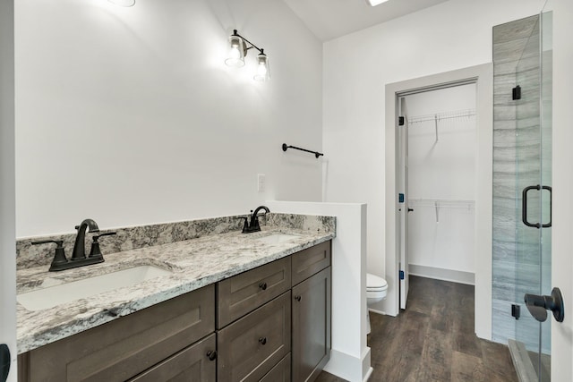 164 Mcnabb Dr, Cleveland, TN 37312 - full bath featuring a shower stall, wood finished floors, a walk in closet, and a sink