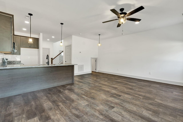 164 Mcnabb Dr, Cleveland, TN 37312 - kitchen featuring light stone counters, a ceiling fan, dark wood-style floors, visible vents, and a peninsula