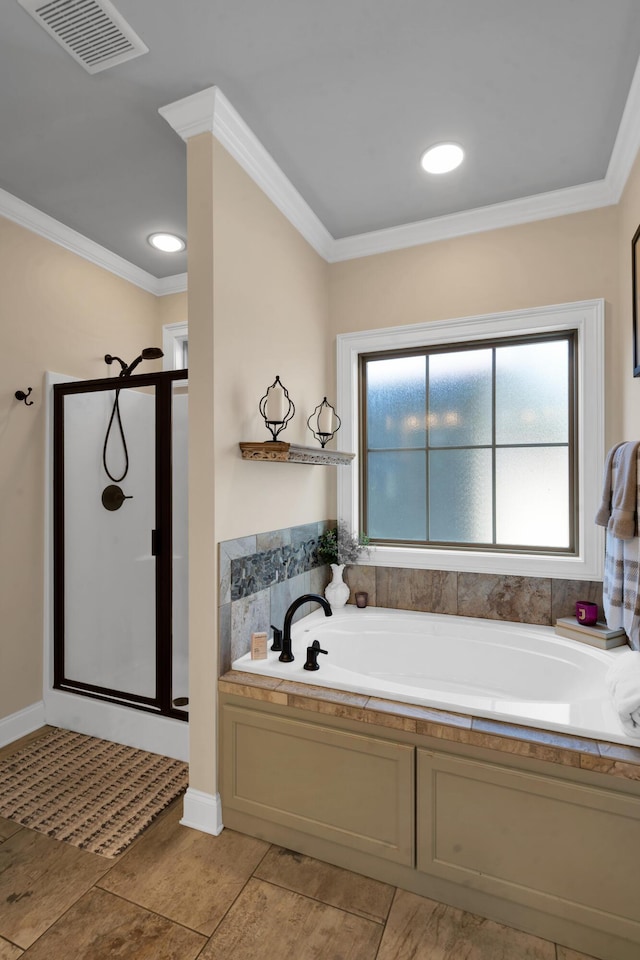 bathroom with visible vents, a garden tub, and ornamental molding