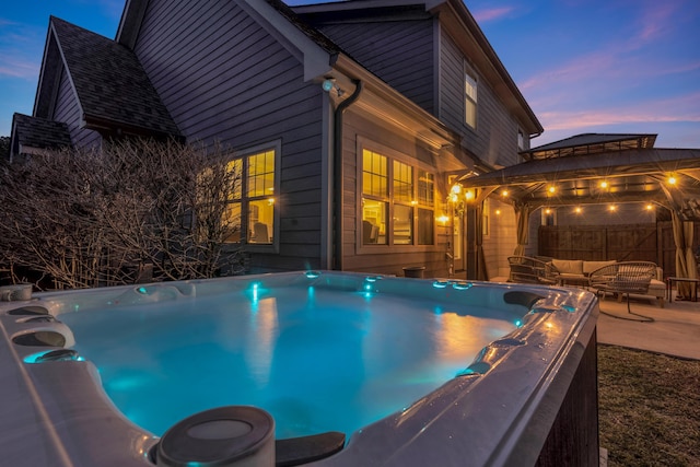 view of swimming pool with a patio, fence, a gazebo, an outdoor hangout area, and a hot tub