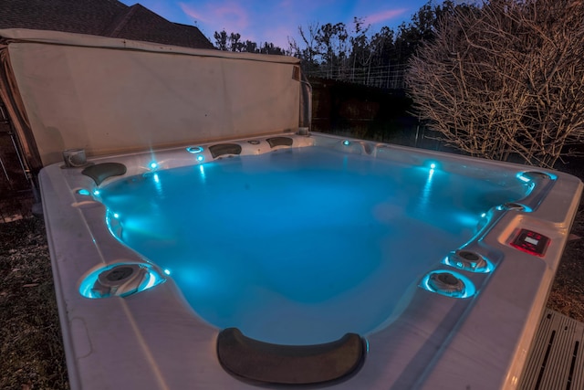 view of swimming pool with a hot tub