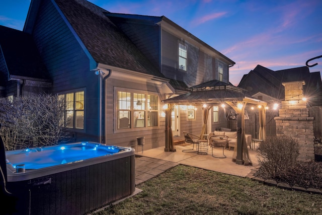 rear view of house featuring a hot tub, a shingled roof, central air condition unit, outdoor lounge area, and a patio area