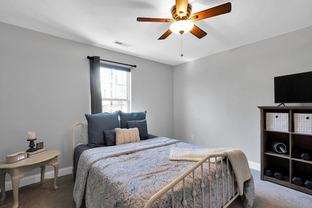 carpeted bedroom with visible vents, baseboards, and a ceiling fan